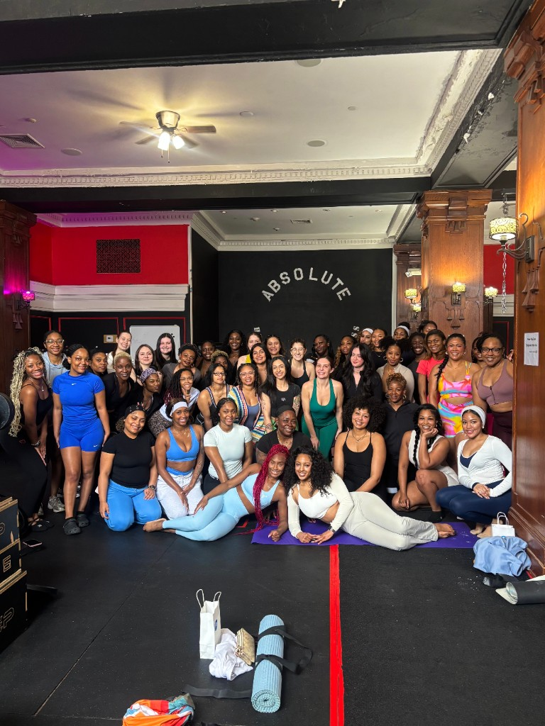 Nellé Mignon with a large group of women after class in a fitness studio