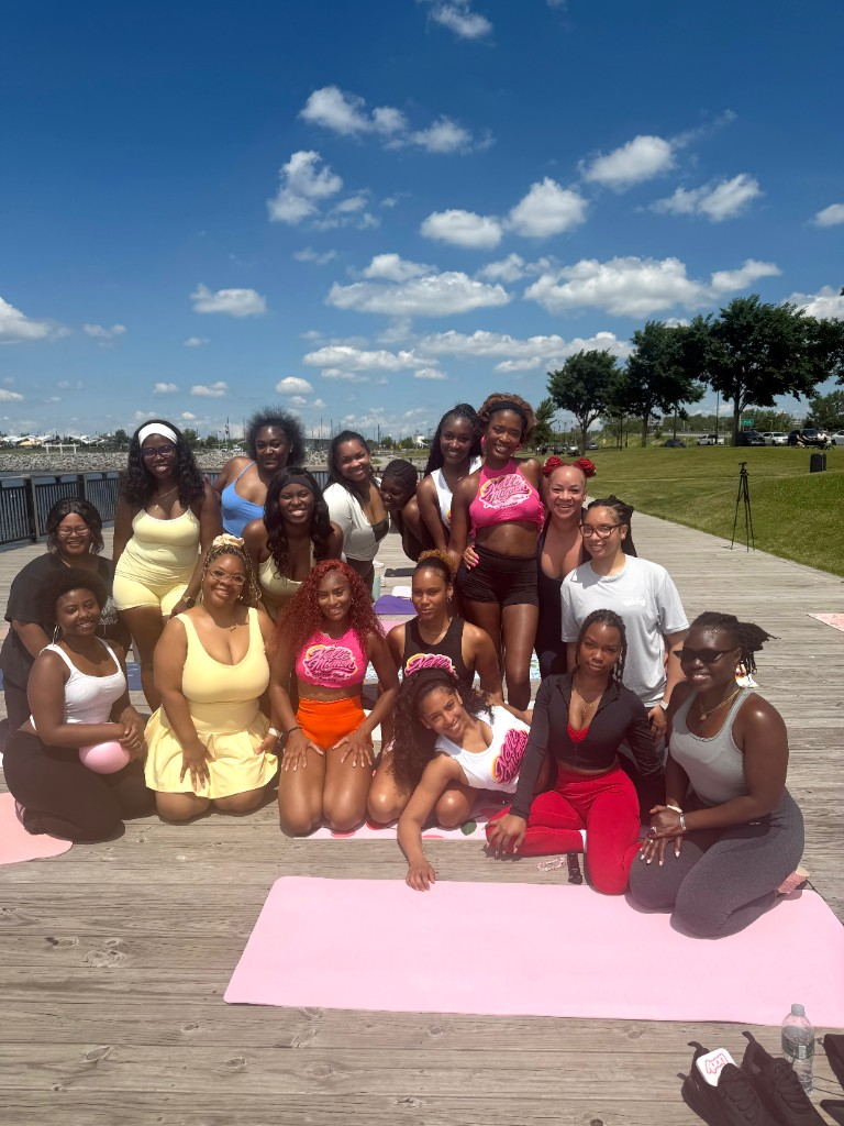 Outdoor community class group smiling together on a wooden deck