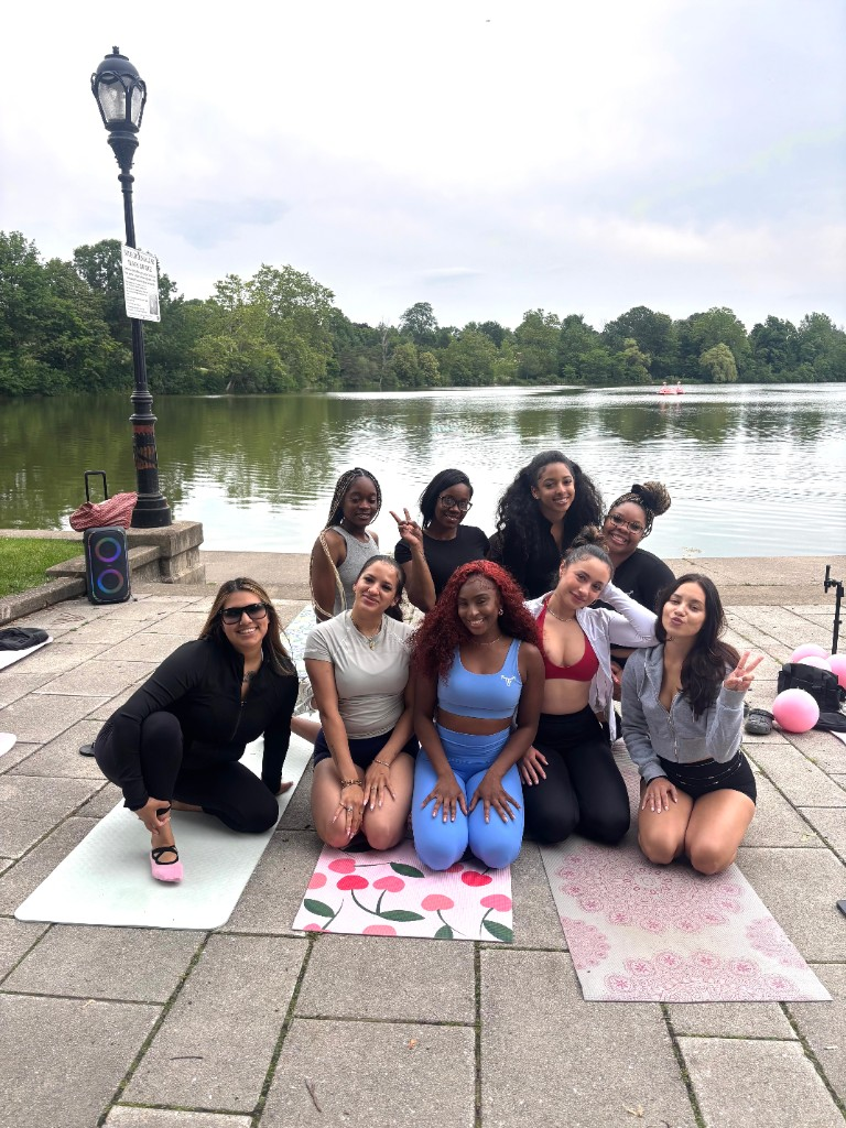 Outdoor wellness group by the water after class
