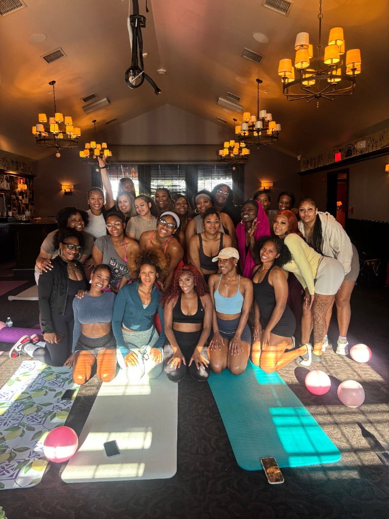 Large group of women smiling together after a studio class